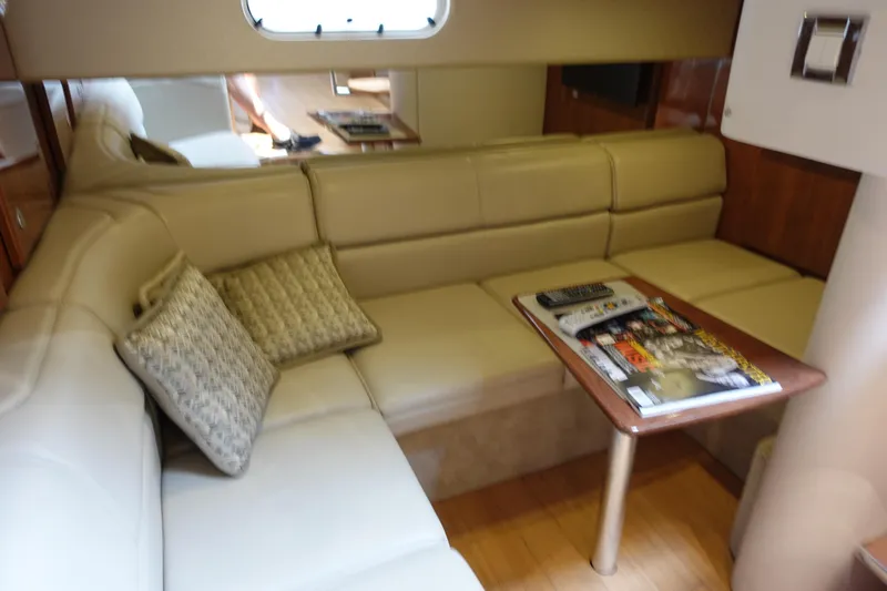  Yacht Photos Pics Interior of 2016 Formula 34 Cruiser with beige seating and wooden table.