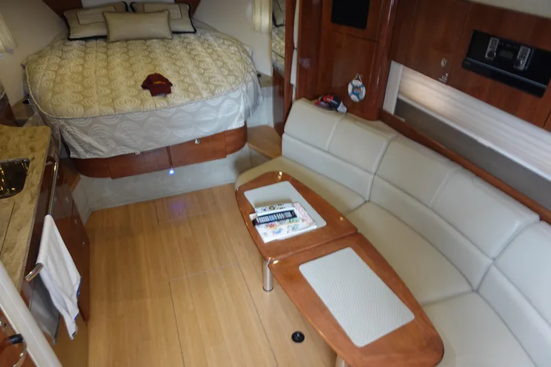  Yacht Photos Pics 2016 Formula 34 Cruiser interior with bed, sofa, and wooden table.