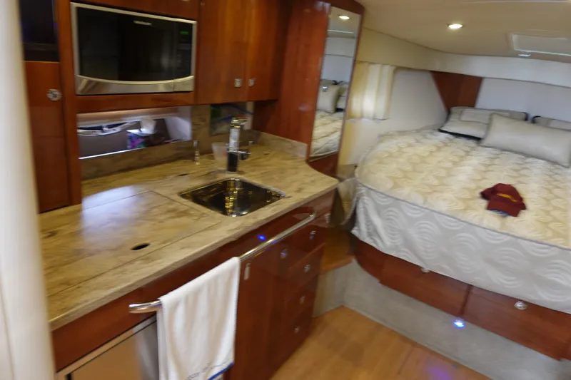 Yacht Photos Pics Interior of 2016 Formula 34 Cruiser with kitchenette and cozy sleeping area.