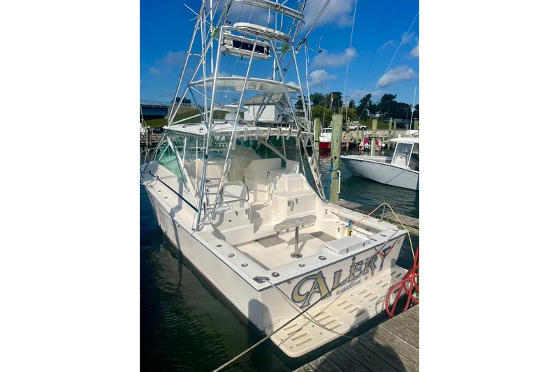  Yacht Photos Pics 2001 Cabo 35 Express boat docked at marina under clear blue sky.