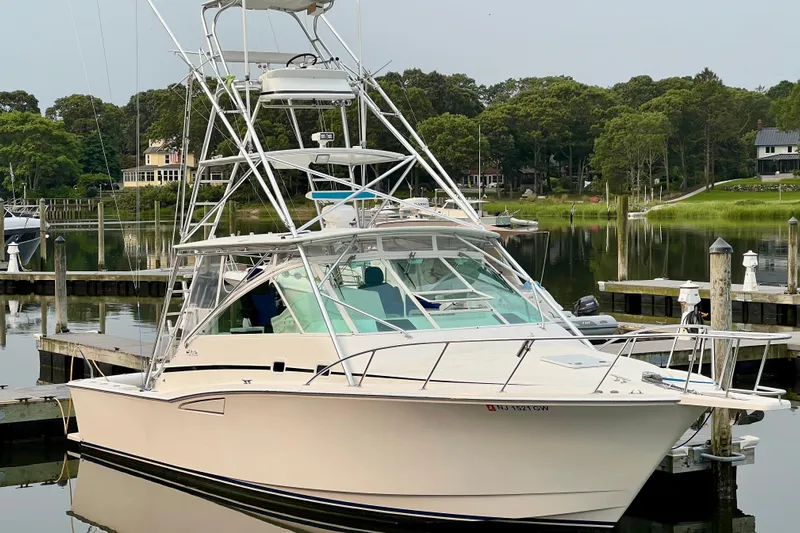  Yacht Photos Pics 2001 Cabo 35 Express boat docked in a serene marina setting.