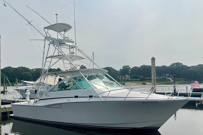  Yacht Photos Pics 2001 Cabo 35 Express boat docked at marina, clear sky, calm water.