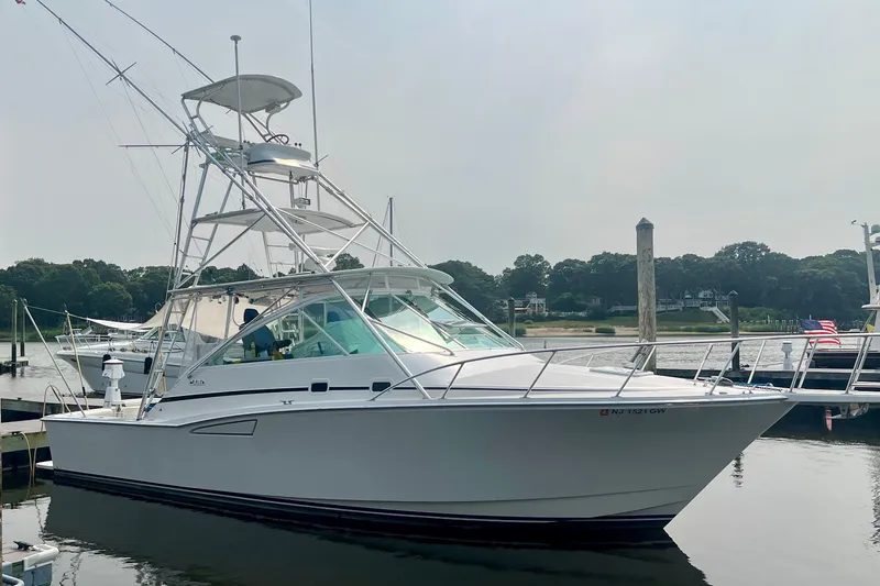 Yacht Photos Pics 2001 Cabo 35 Express yacht docked at a marina, side view.