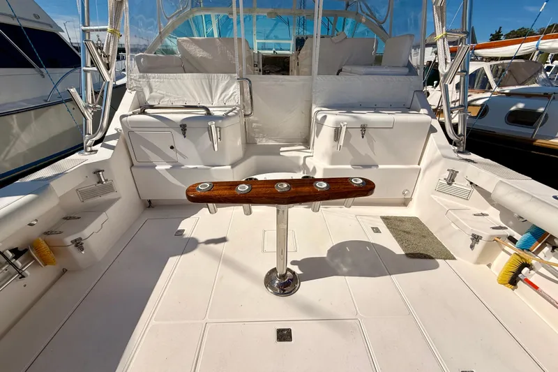  Yacht Photos Pics 2001 Cabo 35 Express boat deck with fishing rod holders and seating area.