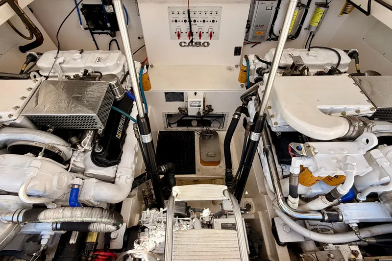  Yacht Photos Pics Engine room of a 2001 Cabo 35 Express boat, showcasing dual engines and mechanical components.