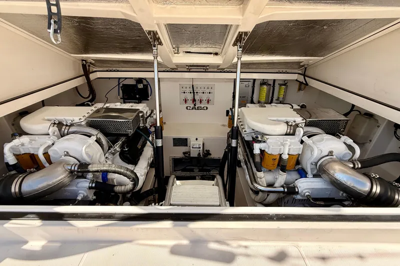  Yacht Photos Pics Engine room of 2001 Cabo 35 Express boat with dual engines and mechanical components.