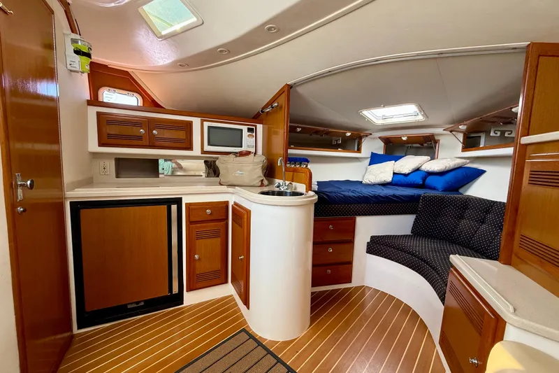  Yacht Photos Pics Interior of 2001 Cabo 35 Express boat with cozy cabin and kitchenette.