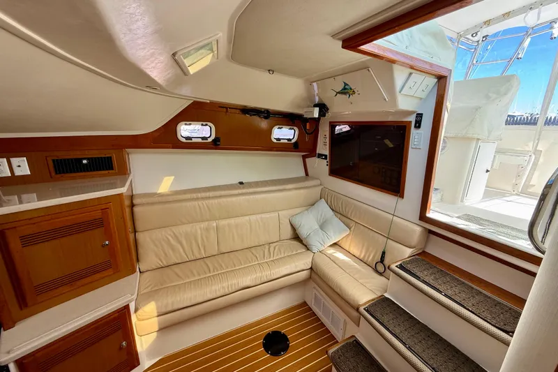  Yacht Photos Pics Interior of 2001 Cabo 35 Express yacht with beige seating and wooden accents.