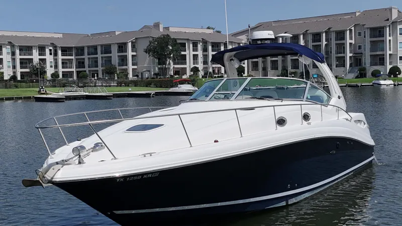 Don't Blink Yacht Photos Pics 2005 Sea Ray 340 Sundancer yacht docked near waterfront apartments.