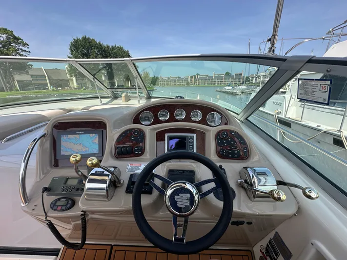 Don't Blink Yacht Photos Pics 2005 Sea Ray 340 Sundancer helm with navigation controls and marina view.