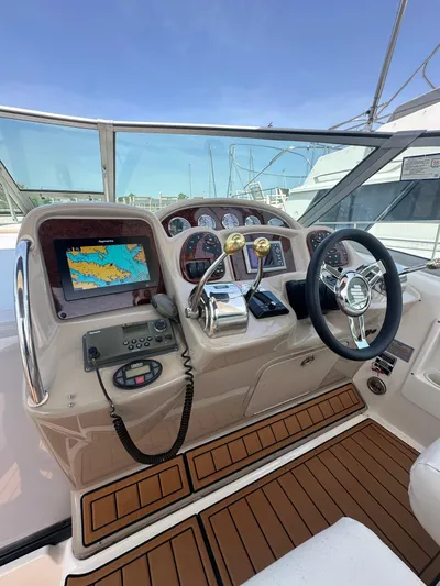 Don't Blink Yacht Photos Pics 2005 Sea Ray 340 Sundancer helm with navigation system and controls, featuring a sleek design.