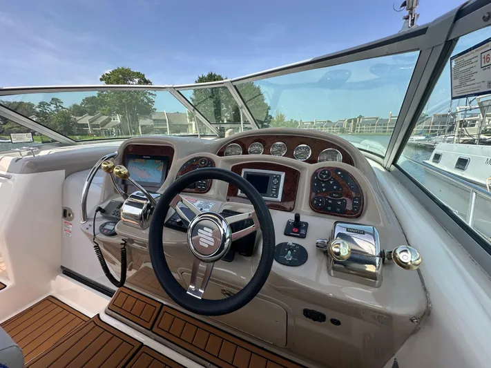 Don't Blink Yacht Photos Pics 2005 Sea Ray 340 Sundancer helm with steering wheel, controls, and navigation system.