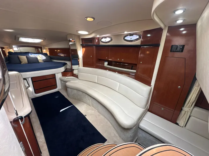 Don't Blink Yacht Photos Pics Luxurious interior of 2005 Sea Ray 340 Sundancer yacht with elegant seating and cozy sleeping area.