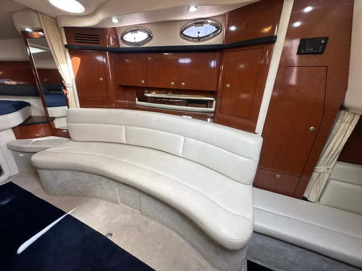 Don't Blink Yacht Photos Pics Luxurious interior of 2005 Sea Ray 340 Sundancer yacht with curved seating and wood cabinetry.