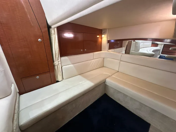 Don't Blink Yacht Photos Pics 2005 Sea Ray 340 Sundancer interior with cream leather seating and wooden cabinetry.