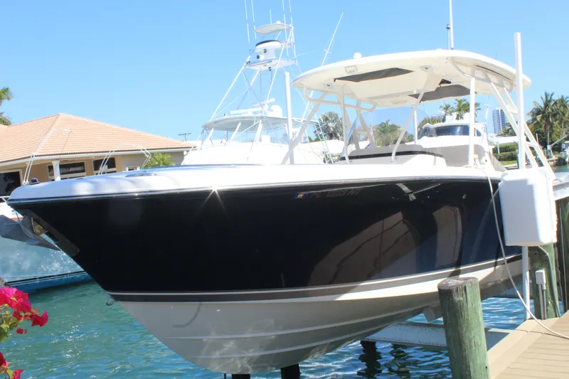  Yacht Photos Pics 2008 Pursuit S 310 Sport boat docked in sunny marina setting.