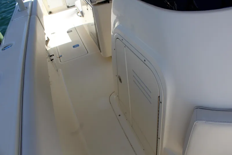  Yacht Photos Pics 2008 Pursuit S 310 Sport boat deck with storage compartment.