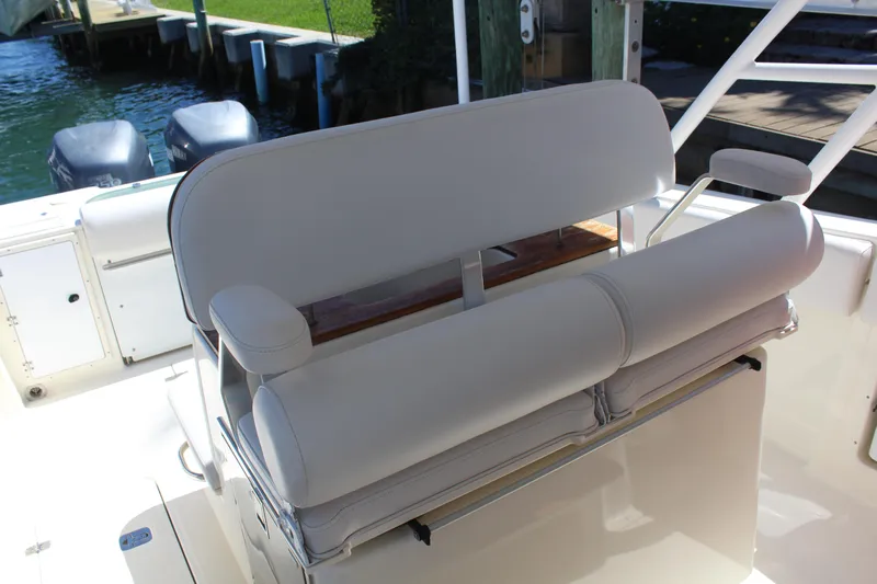  Yacht Photos Pics 2008 Pursuit S 310 Sport boat seating area with white cushioned bench.