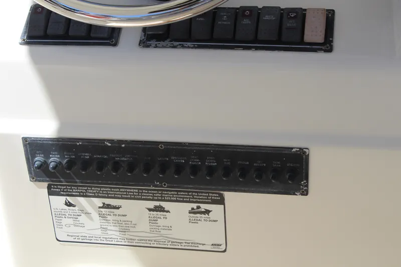  Yacht Photos Pics Control panel of a 2008 Pursuit S 310 Sport boat with switches and labels.