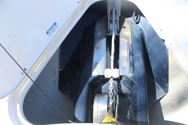  Yacht Photos Pics Anchor compartment of 2008 Pursuit S 310 Sport boat, showcasing chain and winch system.