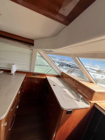 No Name Yacht Photos Pics Interior of 2016 Riviera 45 OPEN yacht with modern kitchen and panoramic windows.