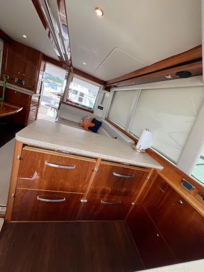 No Name Yacht Photos Pics Interior of 2016 Riviera 45 OPEN yacht with wooden cabinetry and modern design.