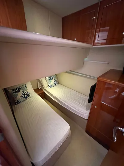 No Name Yacht Photos Pics 2016 Riviera 45 OPEN cabin with twin beds and wooden cabinetry.
