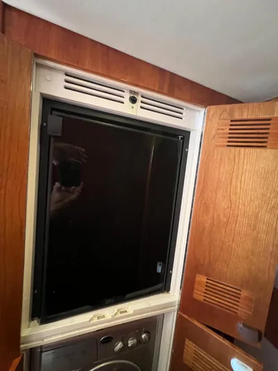 No Name Yacht Photos Pics Interior of 2016 Riviera 45 OPEN yacht with wooden cabinetry and built-in appliance.