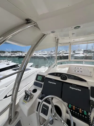 No Name Yacht Photos Pics Riviera 45 OPEN 2016 yacht helm with marina view, featuring Raymarine navigation systems.