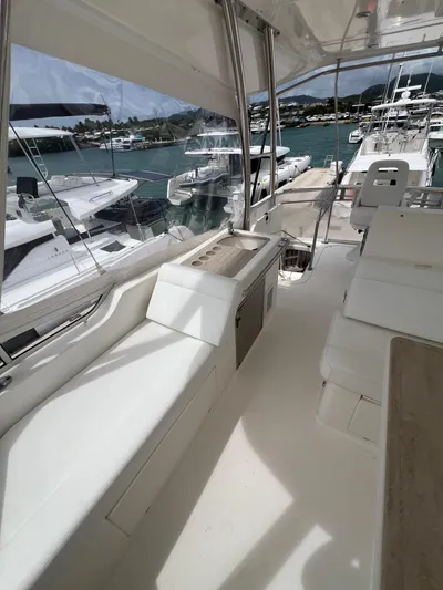 No Name Yacht Photos Pics 2016 Riviera 45 OPEN yacht interior with marina view, featuring sleek white seating and modern design.