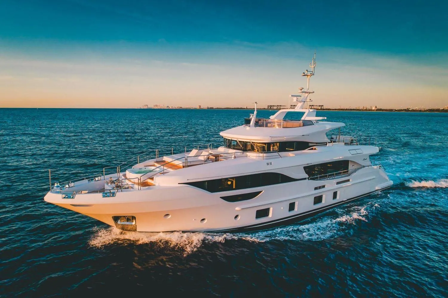 Luxury Benetti Delfino Co Ownership yacht cruising at sunset, 2020 model.