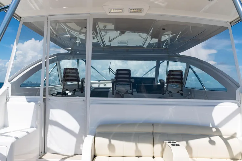  Yacht Photos Pics 2021 Viking 44 Open yacht interior with helm chairs and panoramic windows.