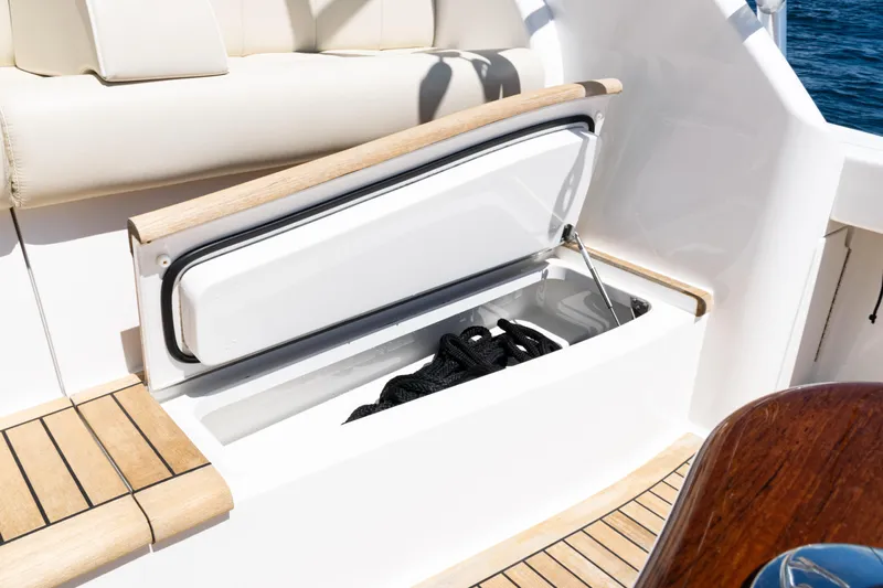  Yacht Photos Pics Open storage compartment on 2021 Viking 44 Open yacht, featuring teak accents and marine rope.