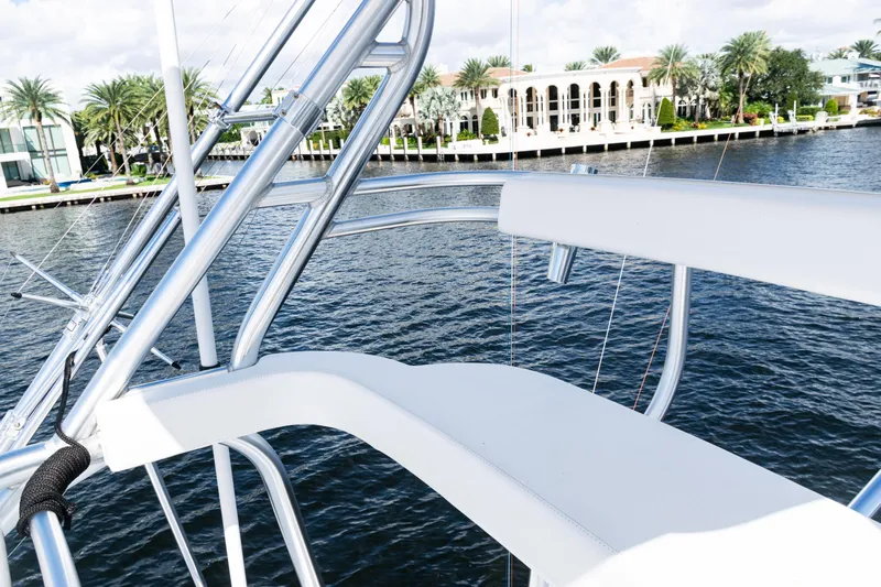  Yacht Photos Pics 2021 Viking 44 Open yacht with sleek railing, overlooking waterfront luxury homes.