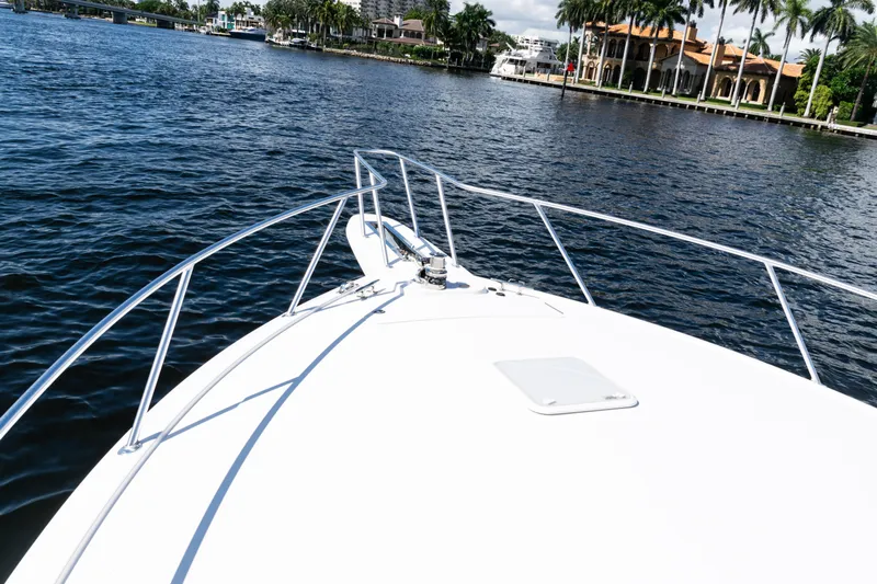  Yacht Photos Pics Bow view of 2021 Viking 44 Open yacht cruising on a scenic waterway.