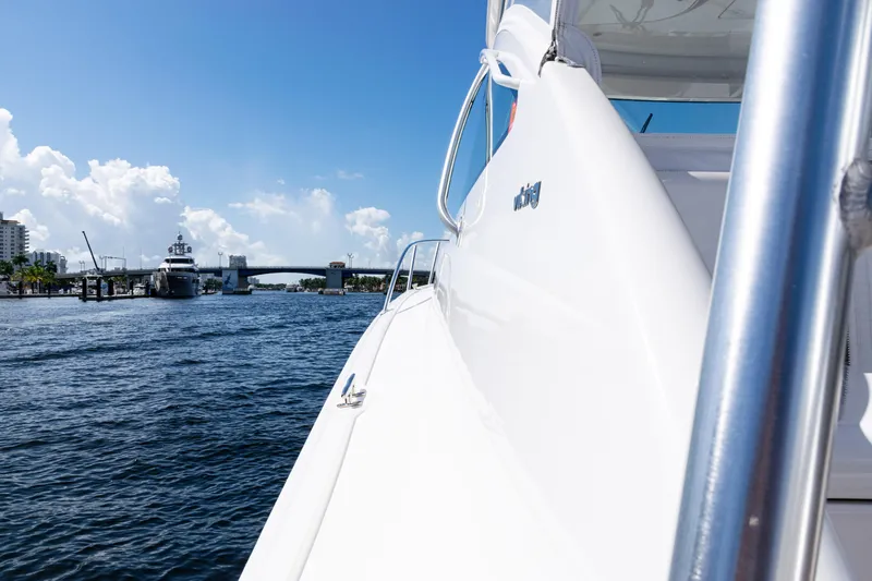  Yacht Photos Pics 2021 Viking 44 Open yacht cruising near a bridge on a sunny day.