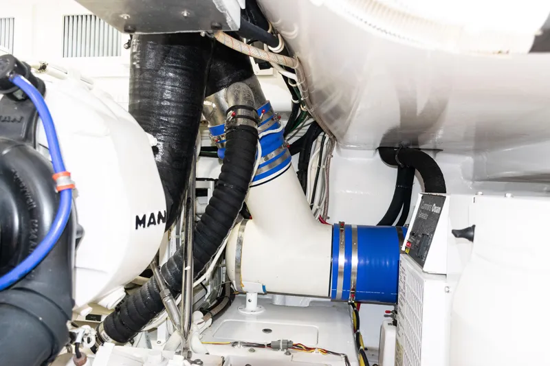  Yacht Photos Pics Engine room of 2021 Viking 44 Open yacht with MAN components and blue hoses.