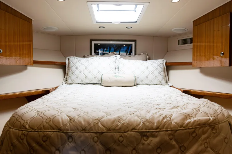  Yacht Photos Pics Luxurious bedroom interior of 2021 Viking 44 Open yacht with elegant bedding.