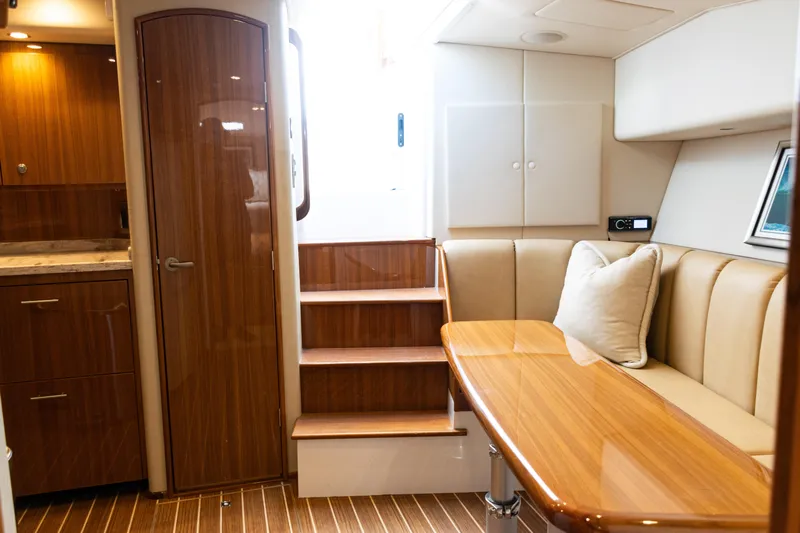  Yacht Photos Pics 2021 Viking 44 Open yacht interior with wooden finishes and cozy seating area.