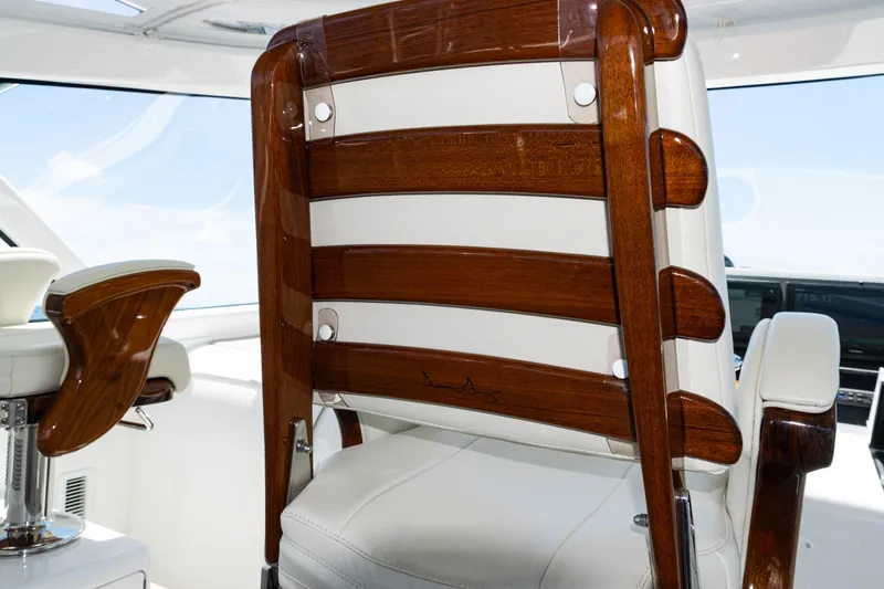  Yacht Photos Pics Luxury seating on 2021 Viking 44 Open yacht, featuring elegant wood and white upholstery.