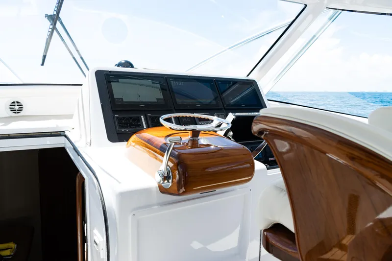  Yacht Photos Pics 2021 Viking 44 Open yacht helm with polished wood and modern navigation displays.