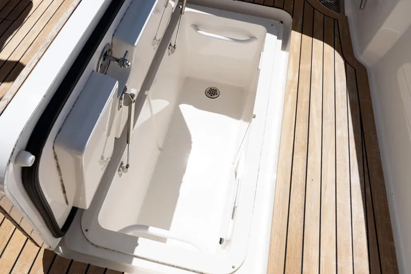  Yacht Photos Pics Open storage compartment on 2021 Viking 44 Open boat with teak flooring.