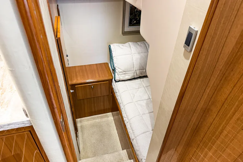  Yacht Photos Pics 2021 Viking 44 Open yacht interior with cozy bunk bed and wooden cabinetry.