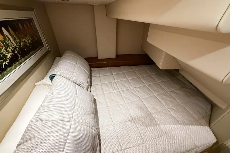  Yacht Photos Pics 2021 Viking 44 Open yacht cabin with cozy bedding and elegant decor.