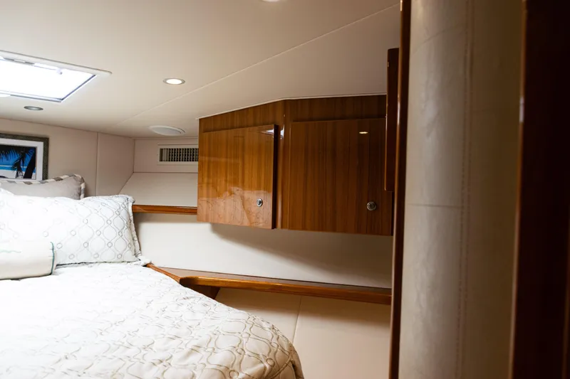  Yacht Photos Pics Luxurious cabin interior of 2021 Viking 44 Open yacht with wood cabinetry.