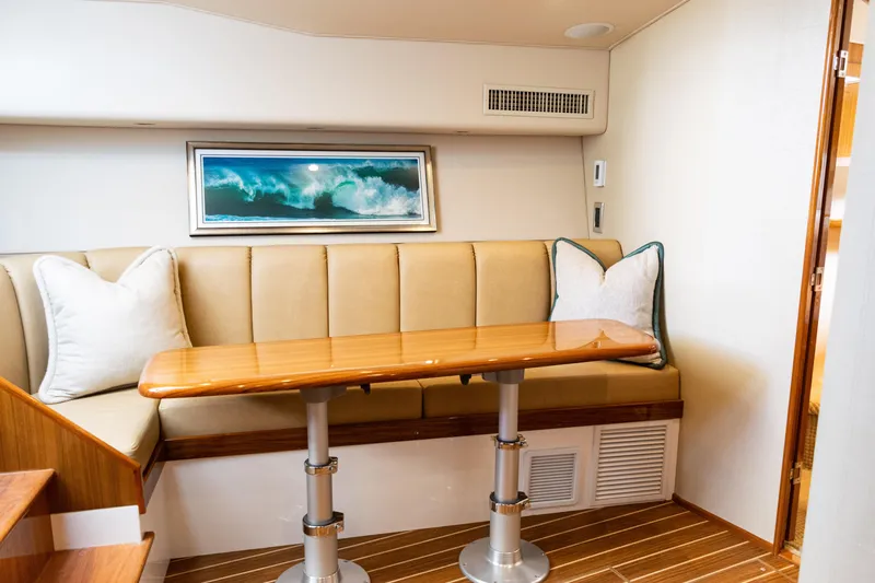  Yacht Photos Pics 2021 Viking 44 Open yacht interior with elegant seating and wooden table.