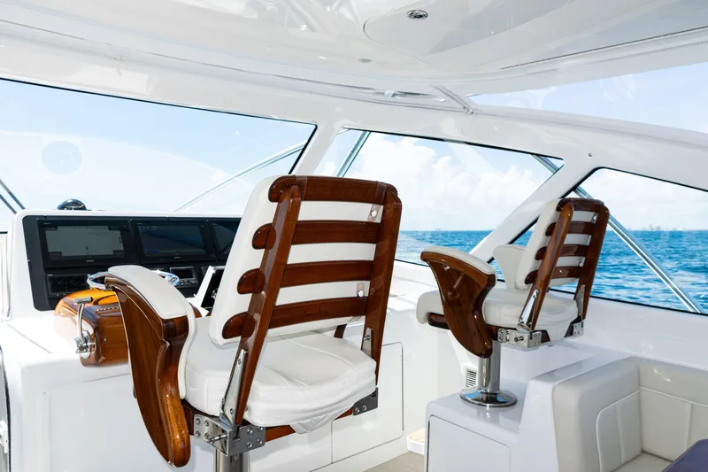  Yacht Photos Pics Interior of 2021 Viking 44 Open yacht with luxurious helm chairs and ocean view.