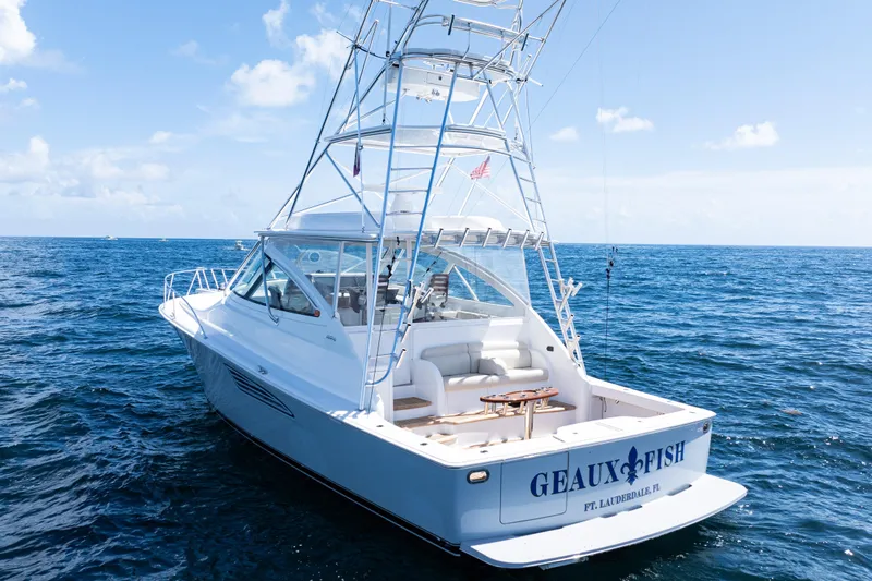  Yacht Photos Pics 2021 Viking 44 Open yacht on ocean, featuring sleek design and fishing tower.