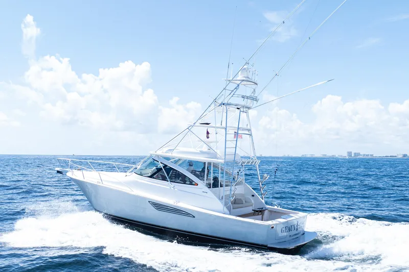  Yacht Photos Pics 2021 Viking 44 Open yacht cruising on the ocean under a clear blue sky.