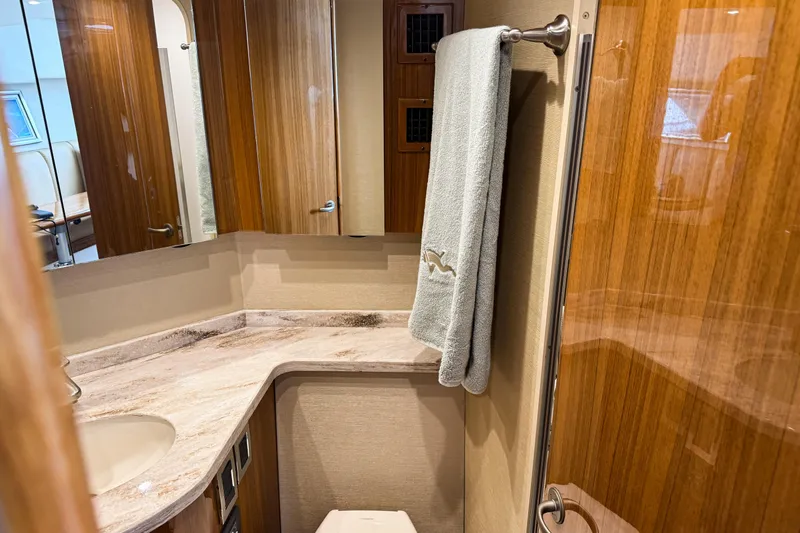  Yacht Photos Pics Luxurious bathroom interior of 2021 Viking 44 Open yacht with wooden finishes.